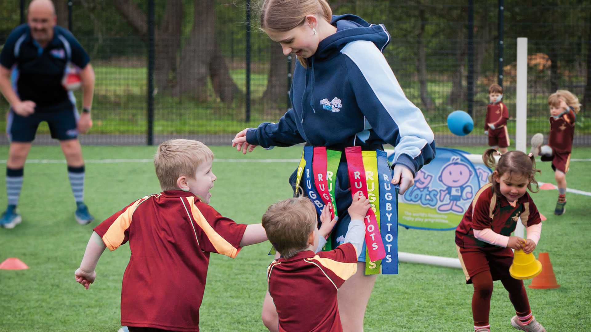 School children taking part in a PE session run by Rugbytots.