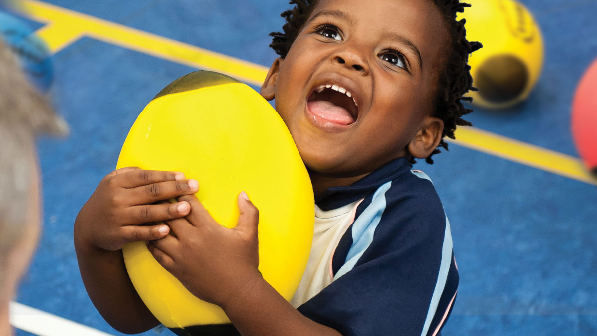 Child catching a Rugbytots foam rugby ball.