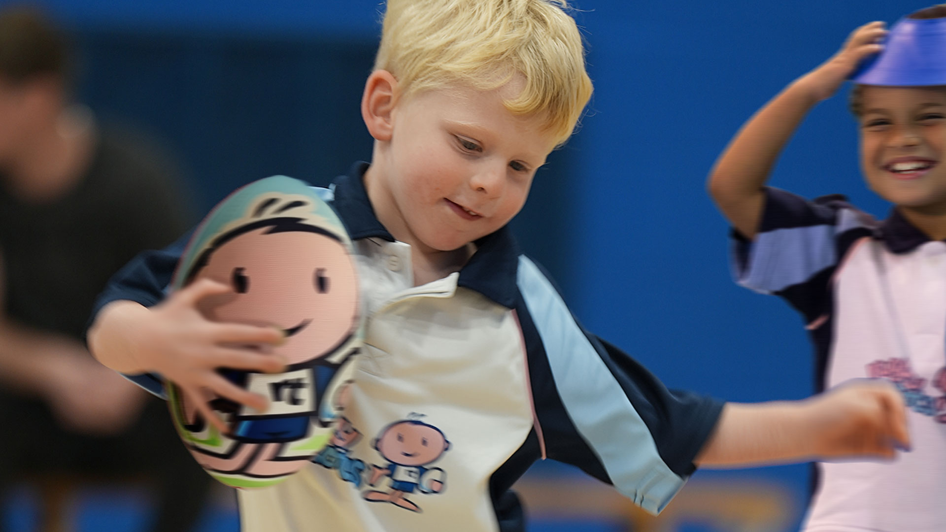 Young boys having having fun at a Rugbytots class.
