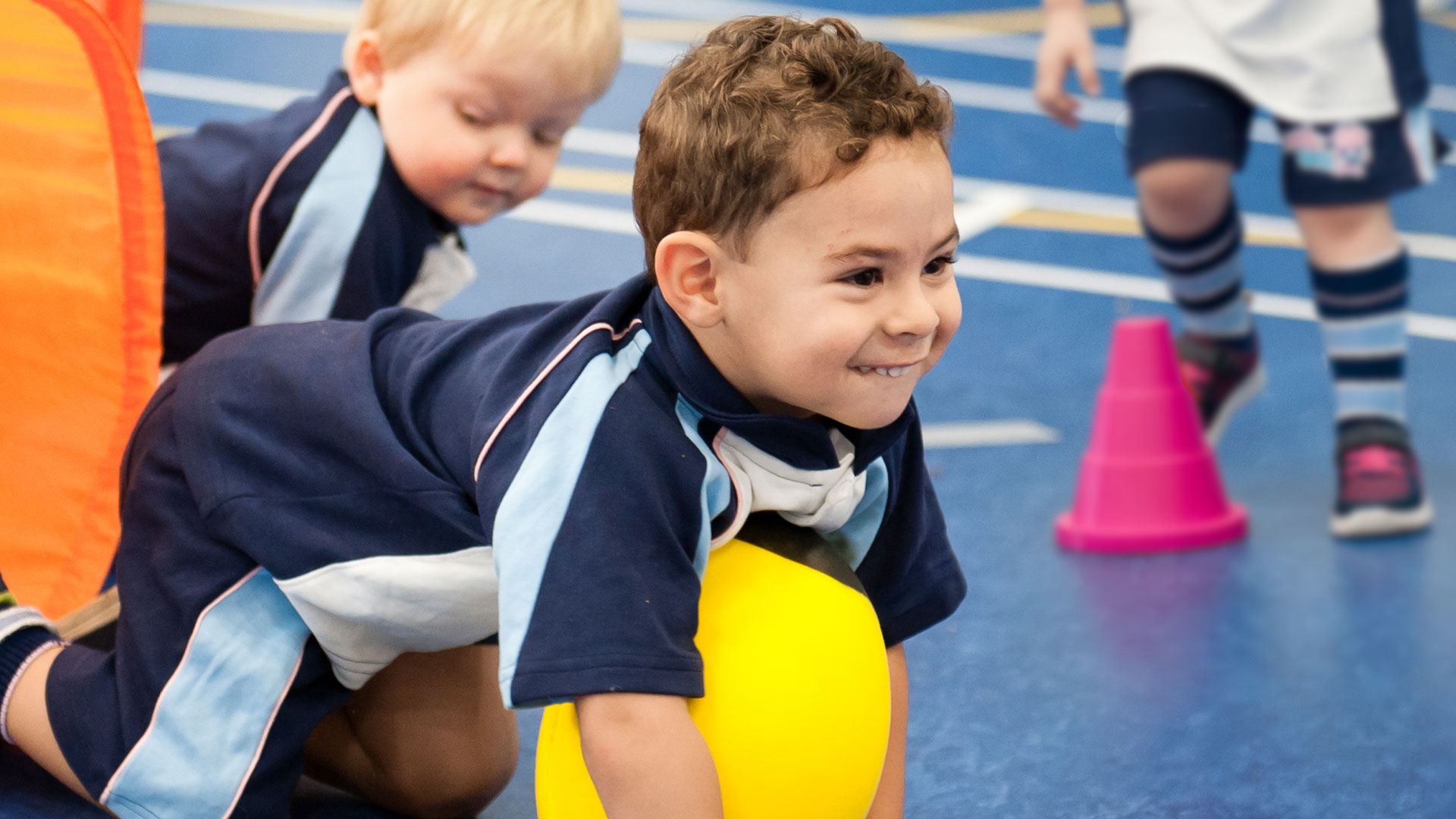 Young children having fun on the Rugbytots obstacle course.